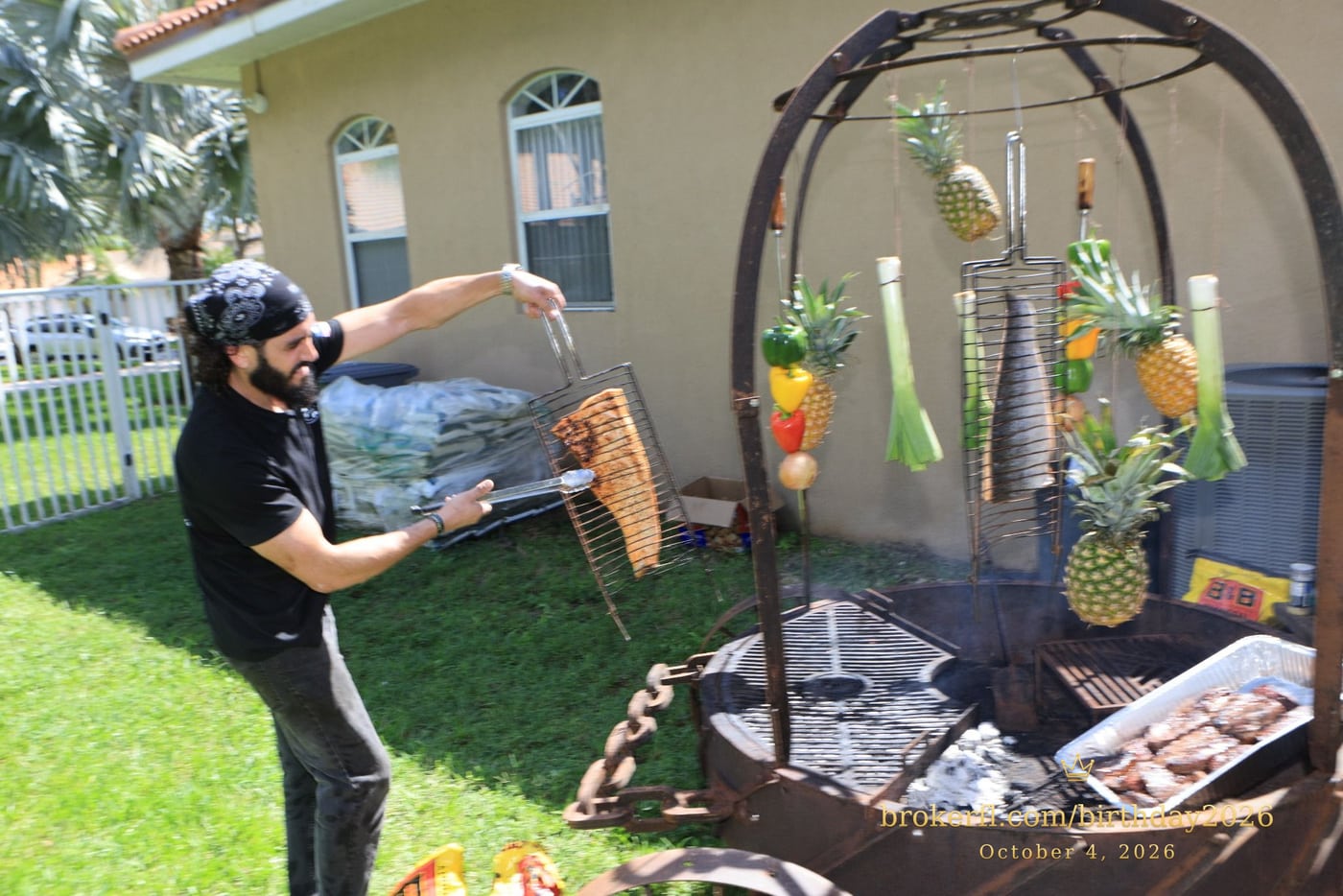 Barbecue cooking over an outdoor fire with hanging vegetables — Karina Leal's birthday, October 4, 2026.