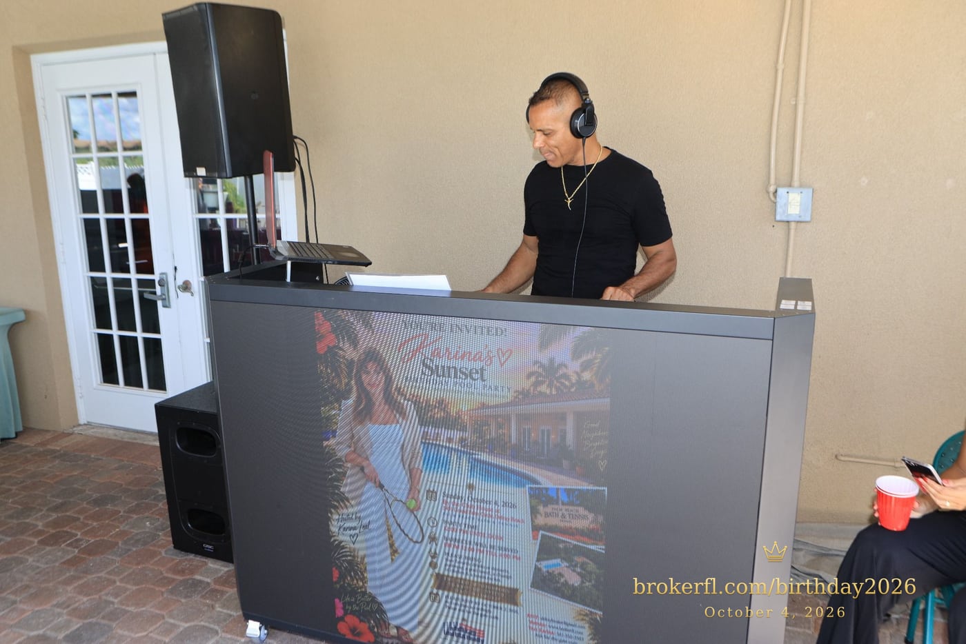 DJ behind the music booth inside the party room — Karina Leal's birthday, October 4, 2026.