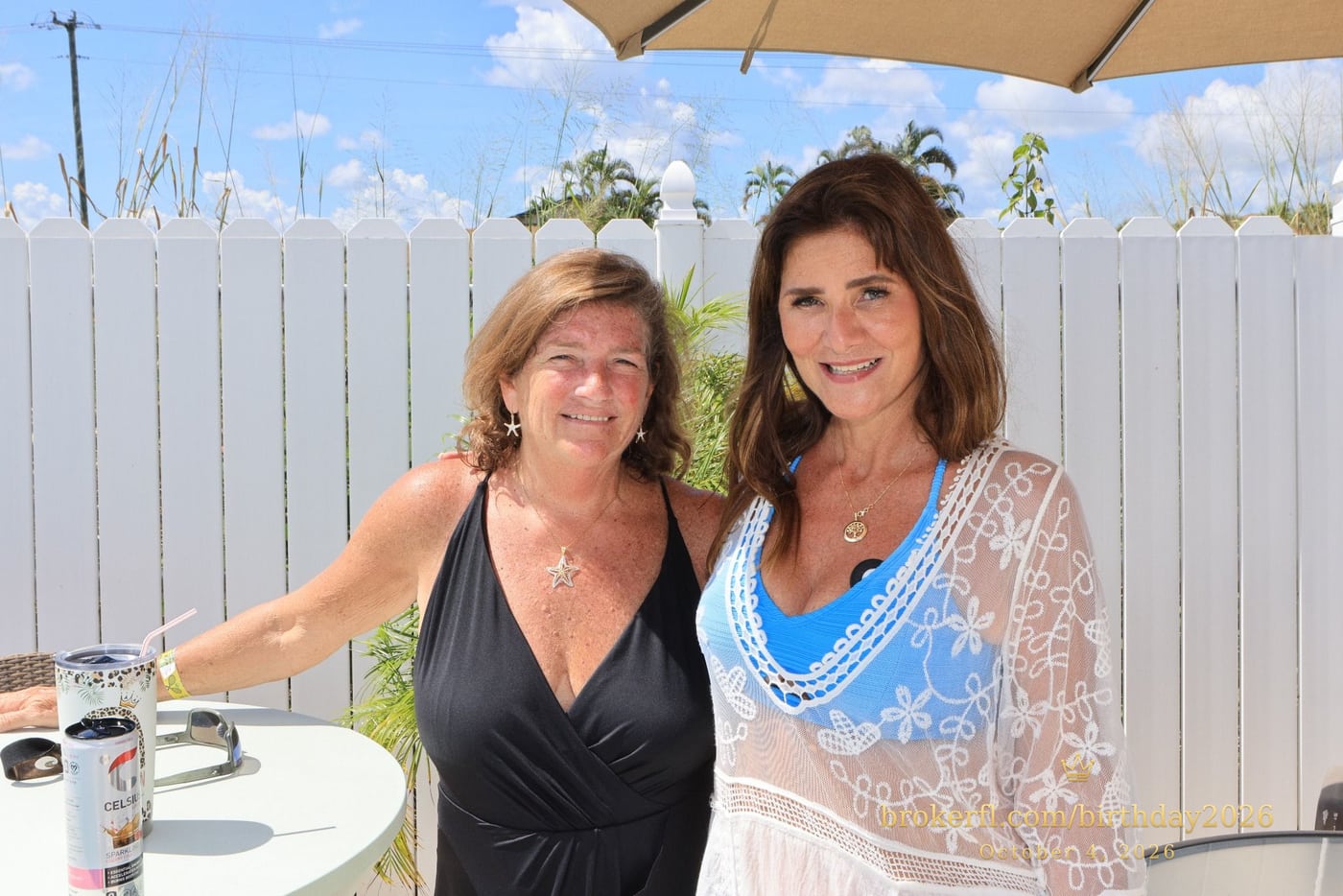 Karina Leal and Laurie Fasolo smiling together beside the pool at Karina’s birthday celebration in Delray Beach.