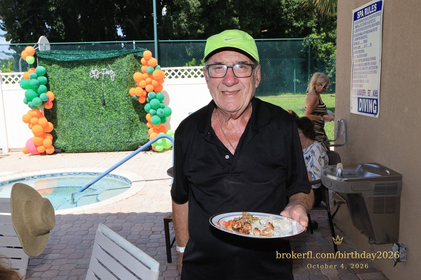 Guest holding a plate on the covered patio — Karina Leal's birthday, October 4, 2026.