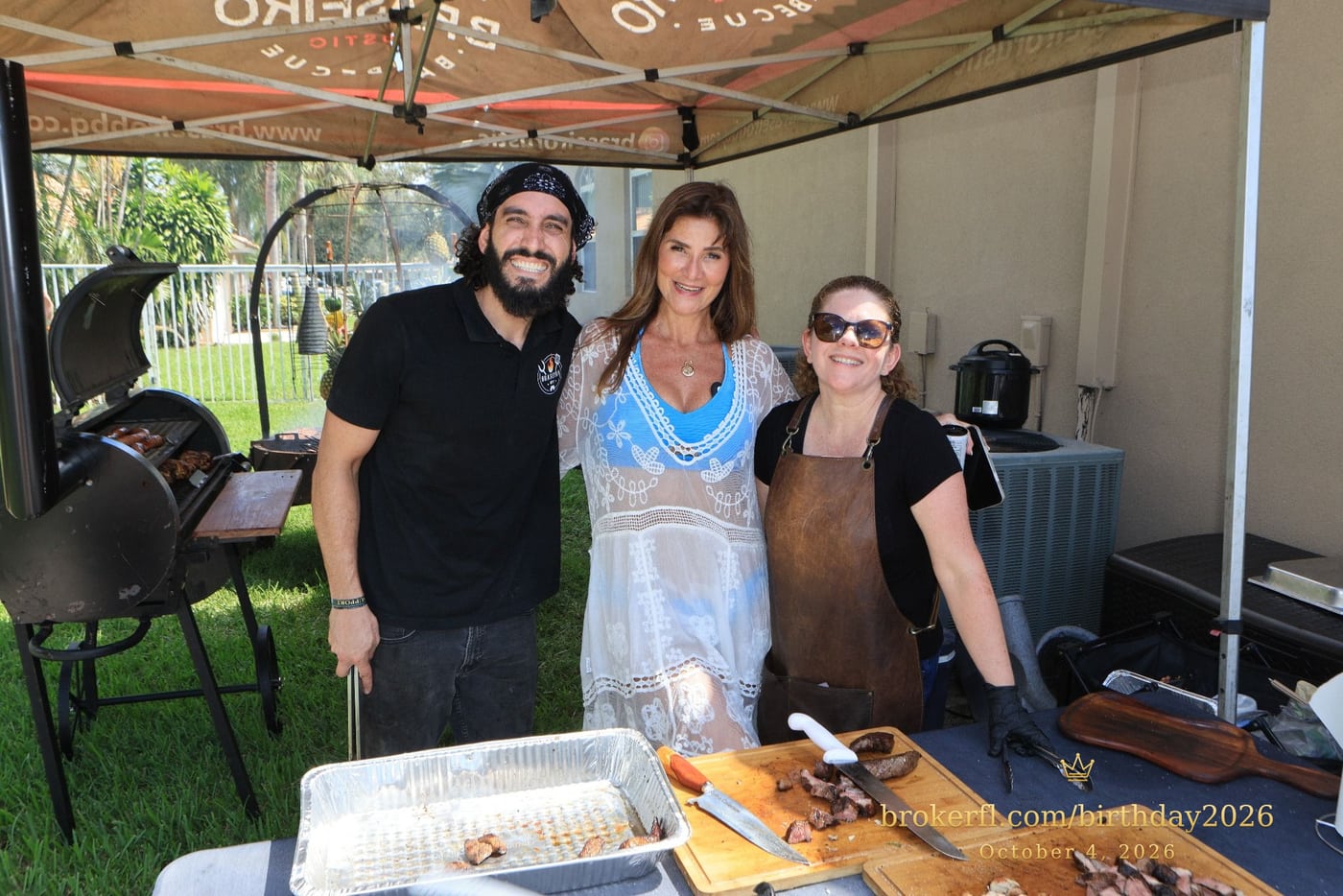 Guests posing with the barbecue team at the outdoor cooking station — Karina Leal's birthday, October 4, 2026.