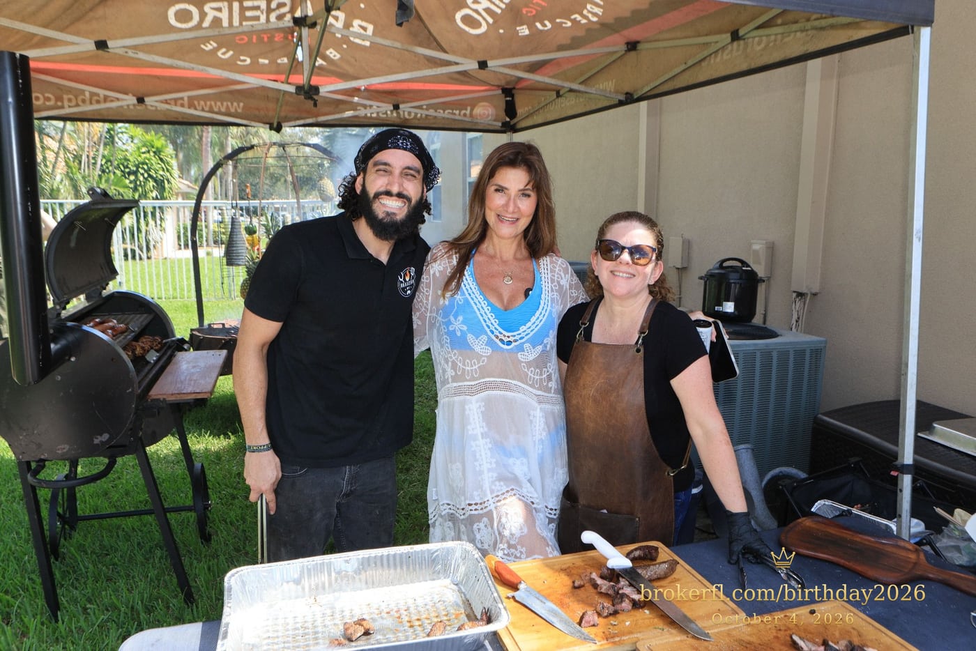 Guests posing with the barbecue team at the outdoor cooking station — Karina Leal's birthday, October 4, 2026.