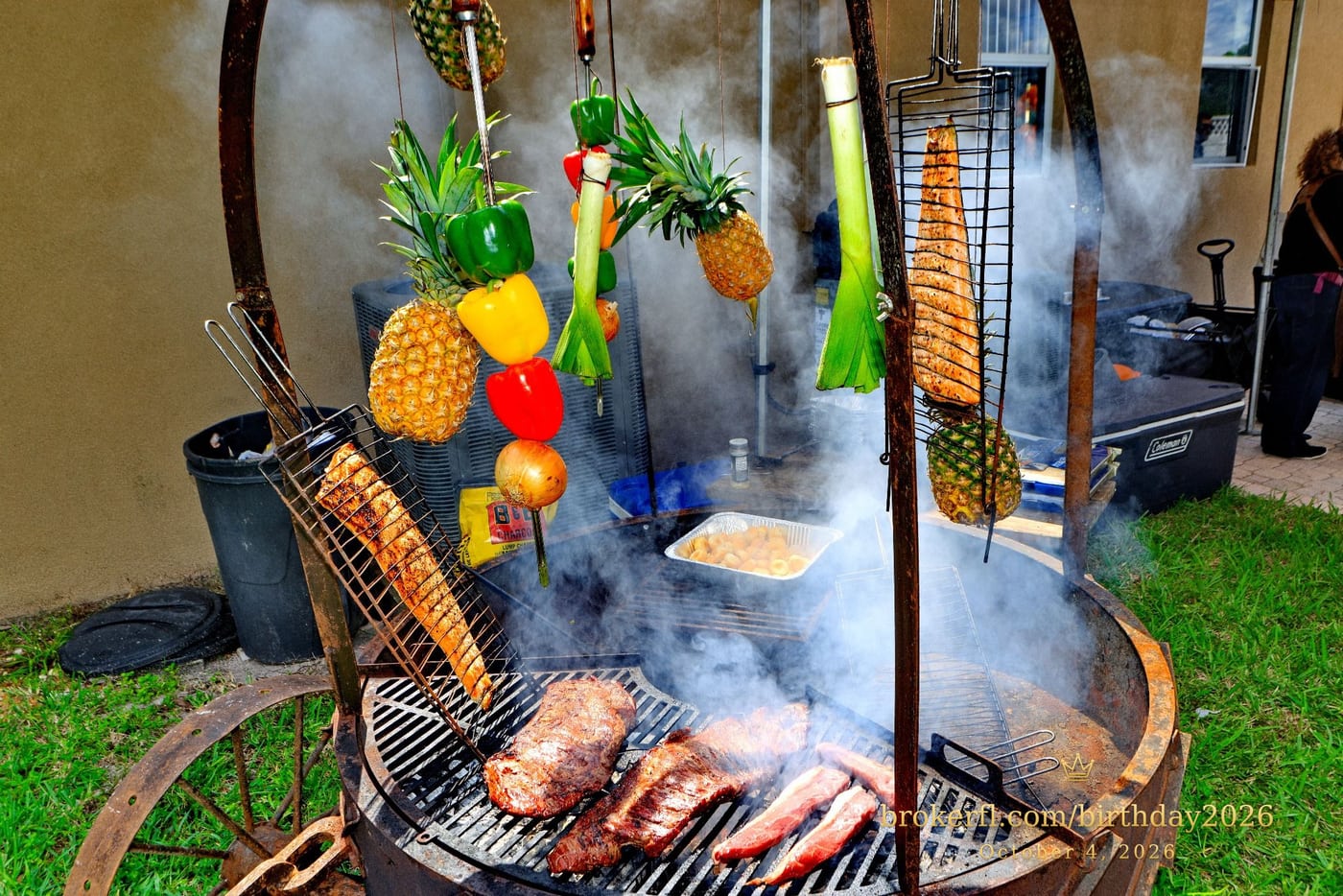 Barbecue cooking over an outdoor fire with hanging vegetables — Karina Leal's birthday, October 4, 2026.