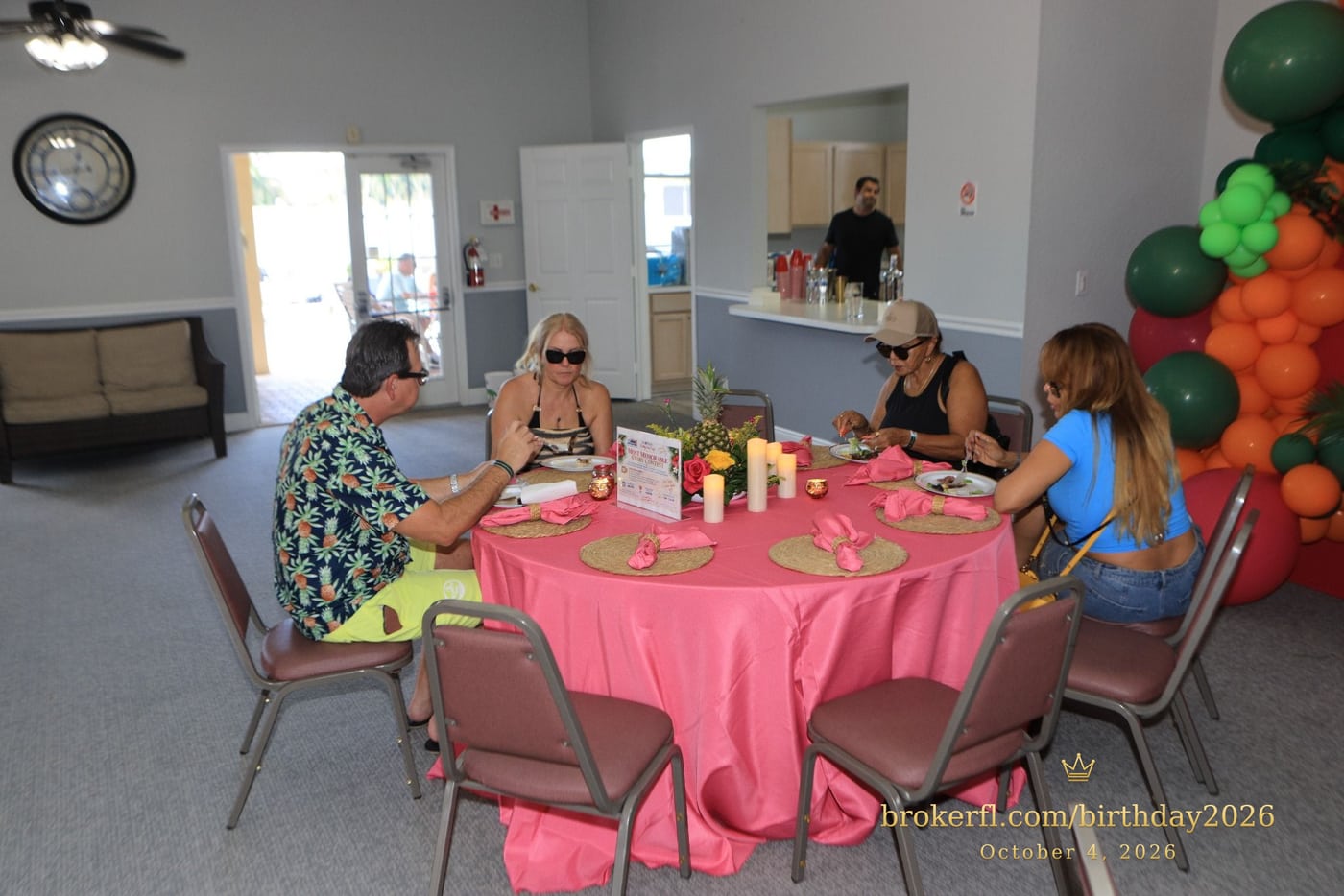 Guests gathered around pink dining tables in the party room — Karina Leal's birthday, October 4, 2026.