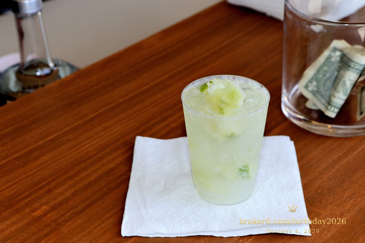Cold lime drink served on a white napkin — Karina Leal's birthday, October 4, 2026.