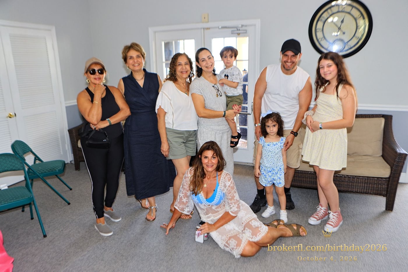 A joyful gathering with Karina Kfuri Leal, seated in front. From left: Neuza Duarte, Luciana Nunes, Marcia Ferreira, Thiago’s wife holding their baby, and Thiago with their two daughters, celebrating Karina’s birthday at Palm Beach Bath & Tennis in Delray Beach.