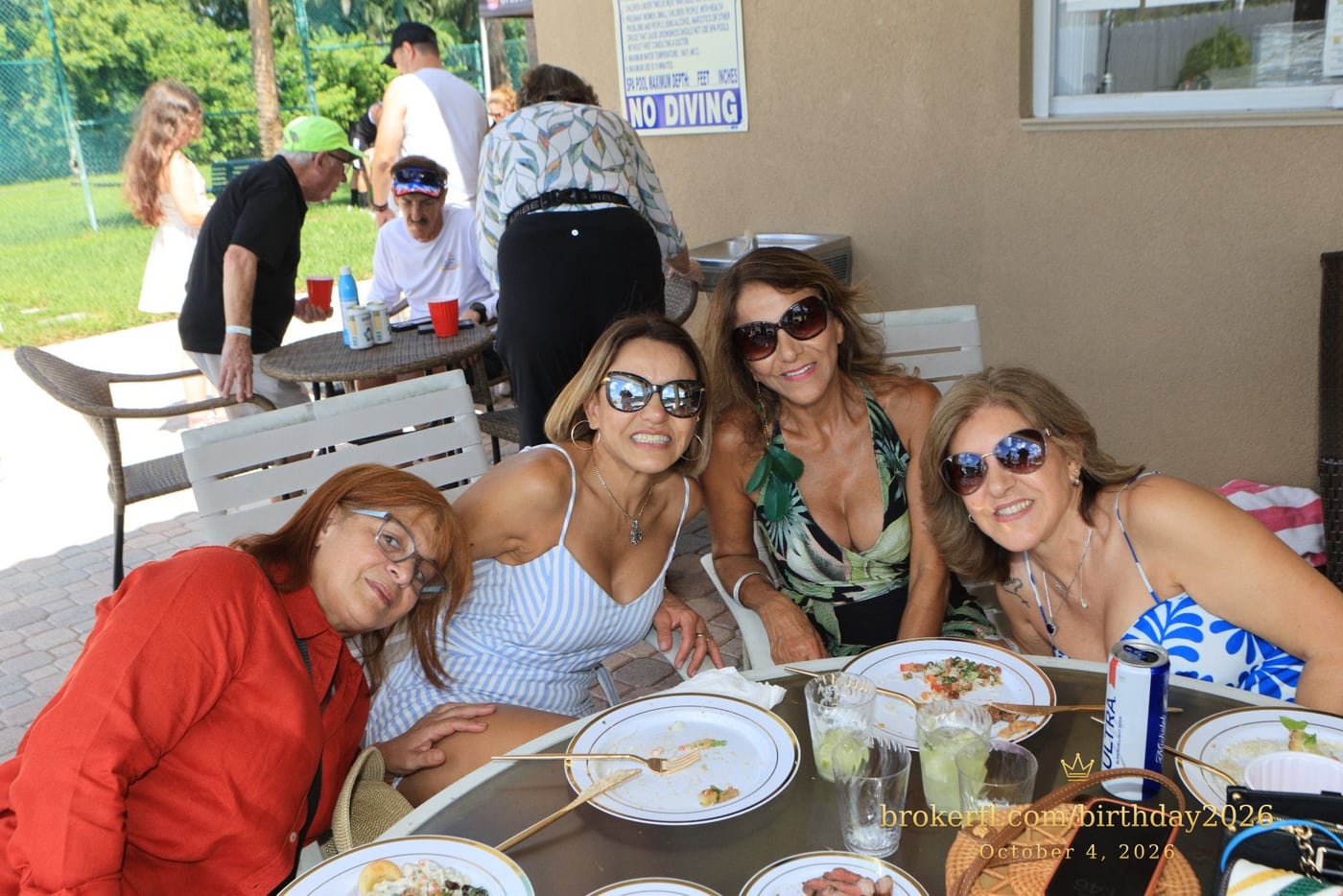 Friends sharing a table on the poolside patio — Karina Leal's birthday, October 4, 2026.