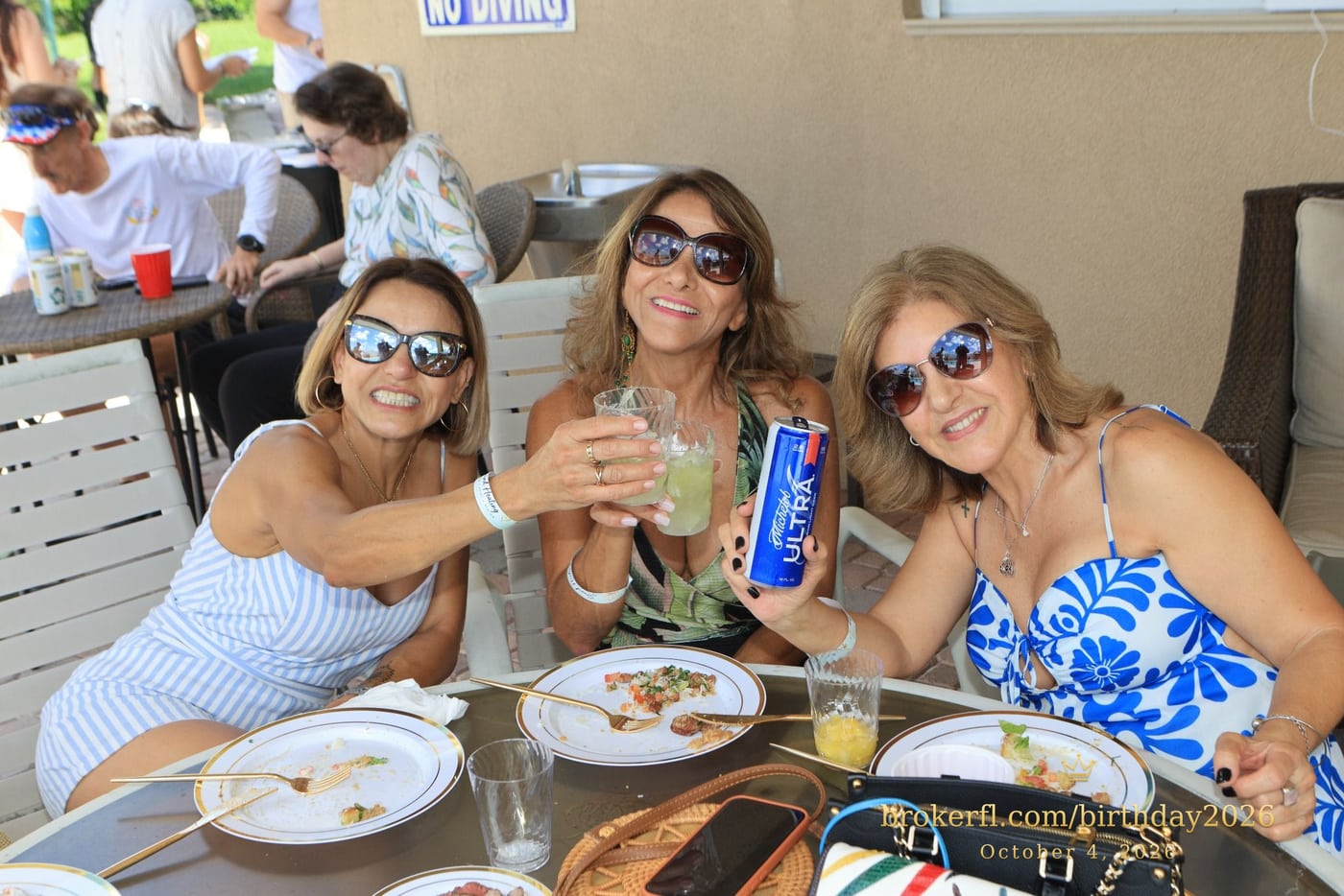 Friends sharing a table on the poolside patio — Karina Leal's birthday, October 4, 2026.