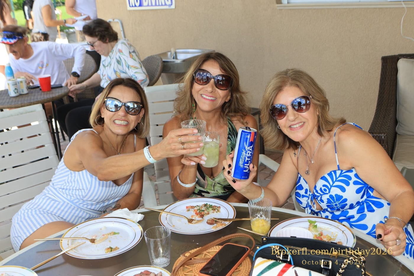 Friends sharing a table on the poolside patio — Karina Leal's birthday, October 4, 2026.
