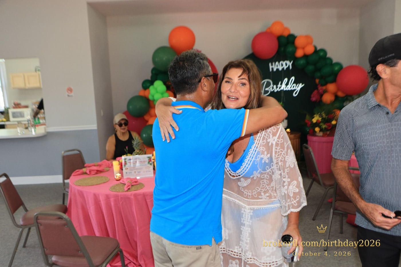 Friends embracing and posing by the birthday backdrop — Karina Leal's birthday, October 4, 2026.