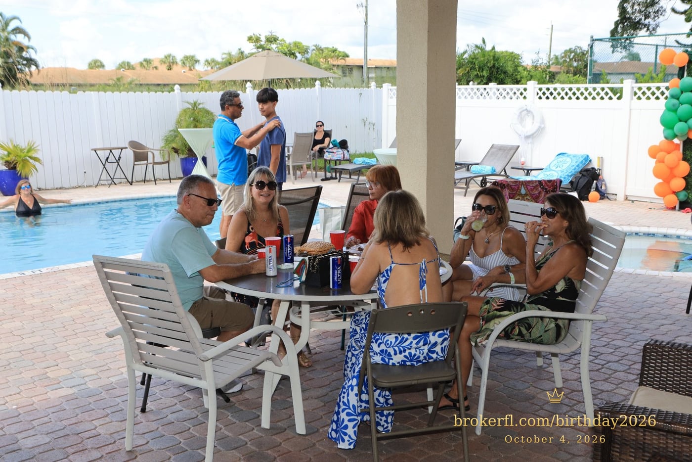 Friends sharing a table on the poolside patio — Karina Leal's birthday, October 4, 2026.