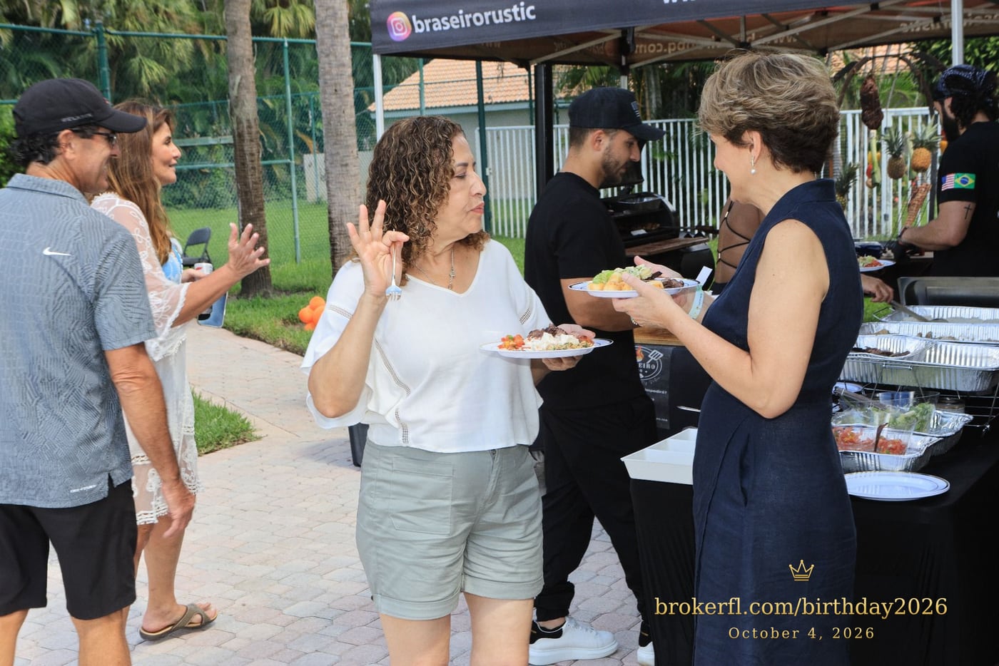 Guests serving themselves at the outdoor buffet — Karina Leal's birthday, October 4, 2026.