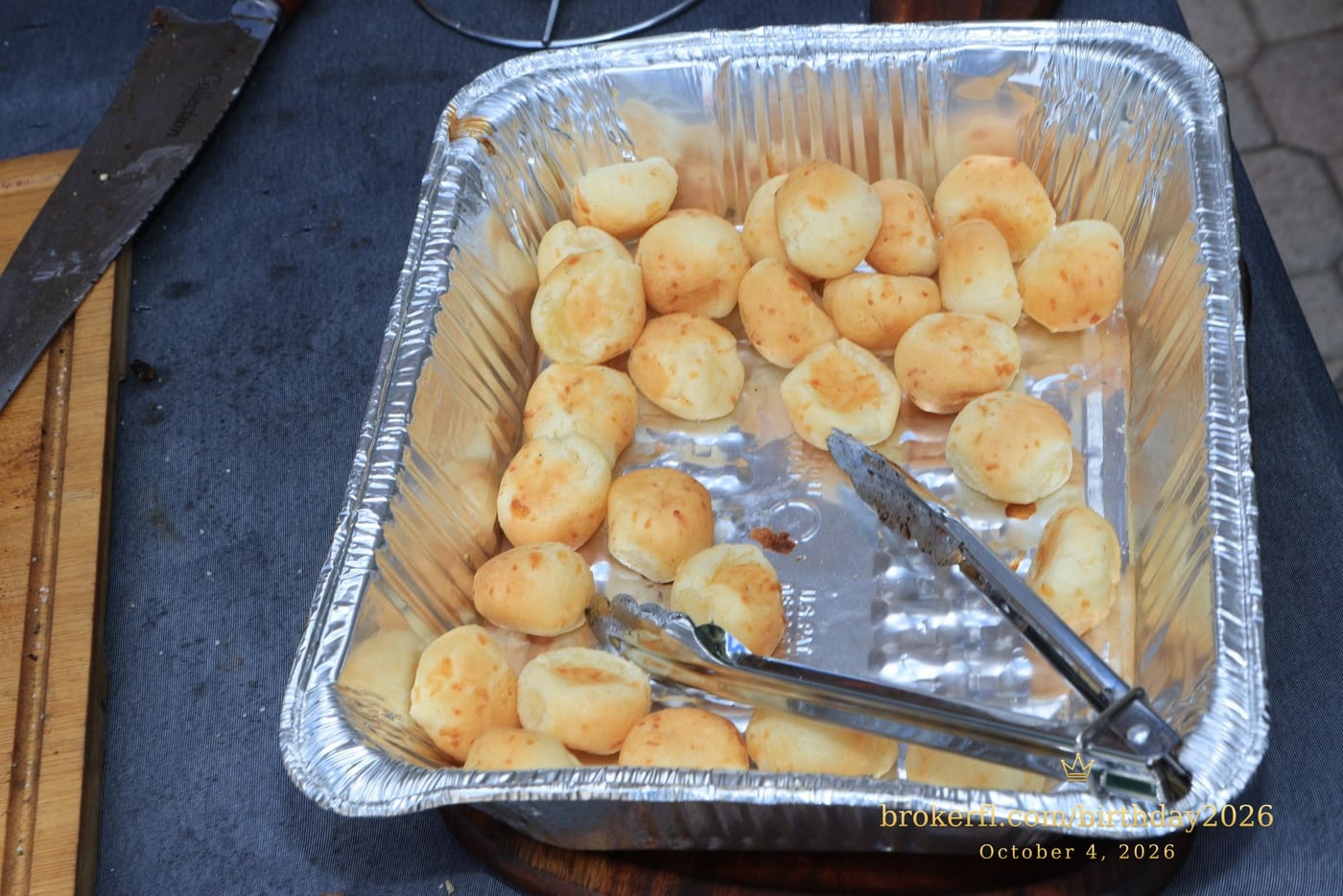 Tray of small golden rolls at the party buffet — Karina Leal's birthday, October 4, 2026.
