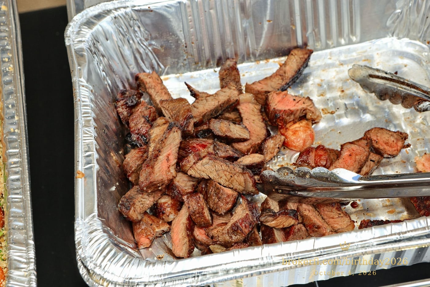 Tray of cooked meat at the party buffet — Karina Leal's birthday, October 4, 2026.