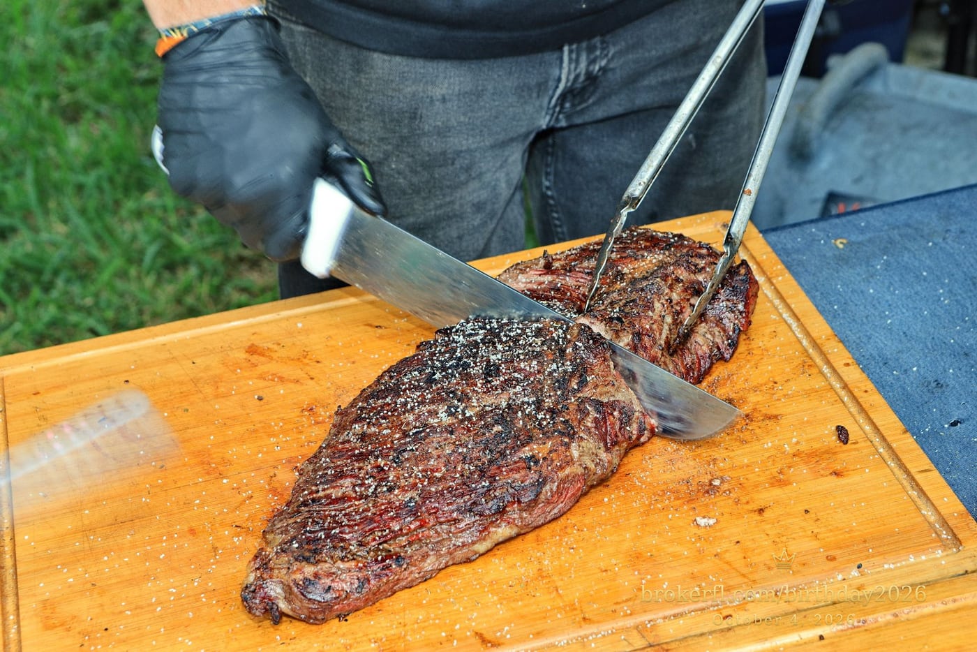 Barbecue meat being sliced on a wooden board — Karina Leal's birthday, October 4, 2026.