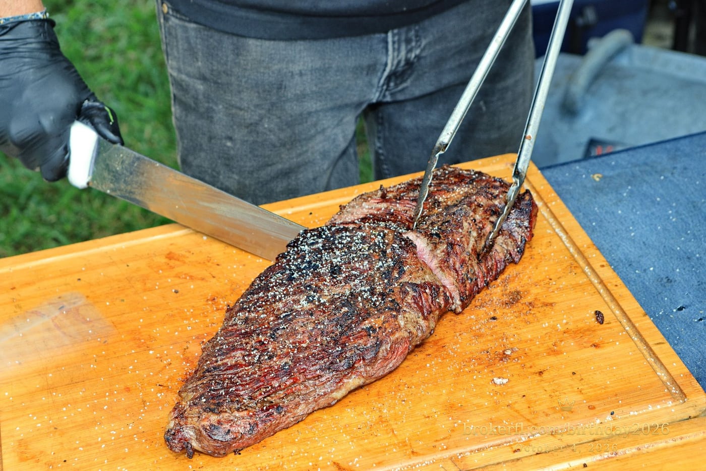 Barbecue meat being sliced on a wooden board — Karina Leal's birthday, October 4, 2026.