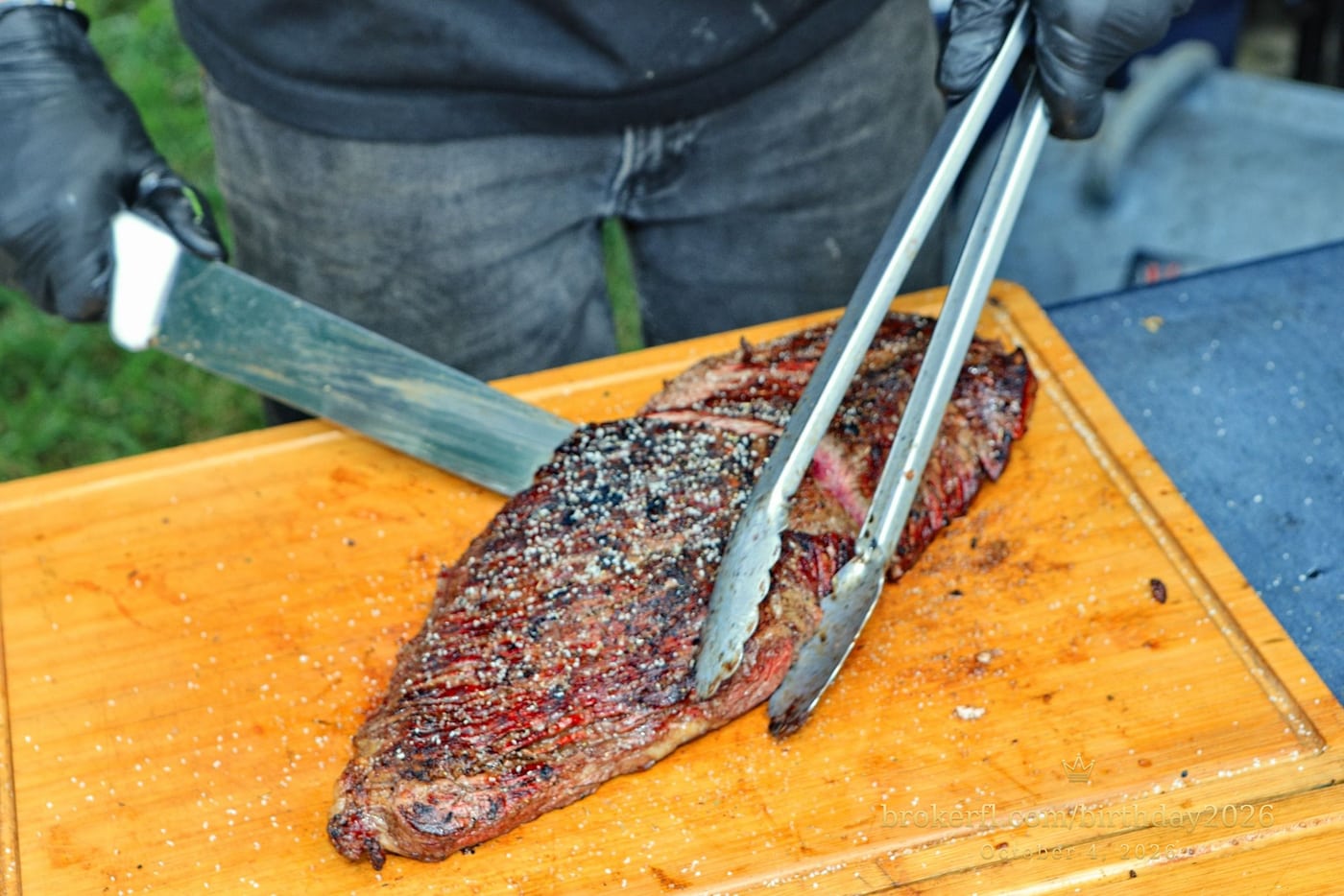 Barbecue meat being sliced on a wooden board — Karina Leal's birthday, October 4, 2026.