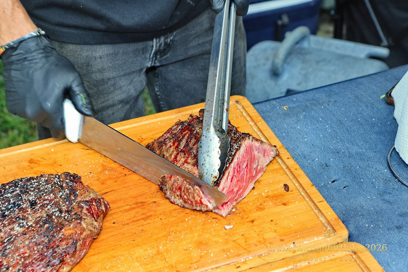 Barbecue meat being sliced on a wooden board — Karina Leal's birthday, October 4, 2026.