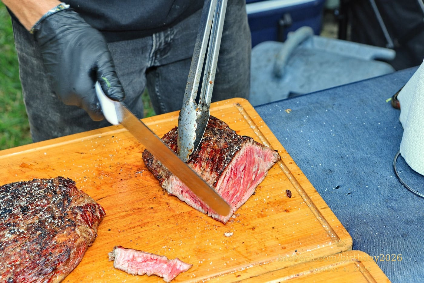 Barbecue meat being sliced on a wooden board — Karina Leal's birthday, October 4, 2026.