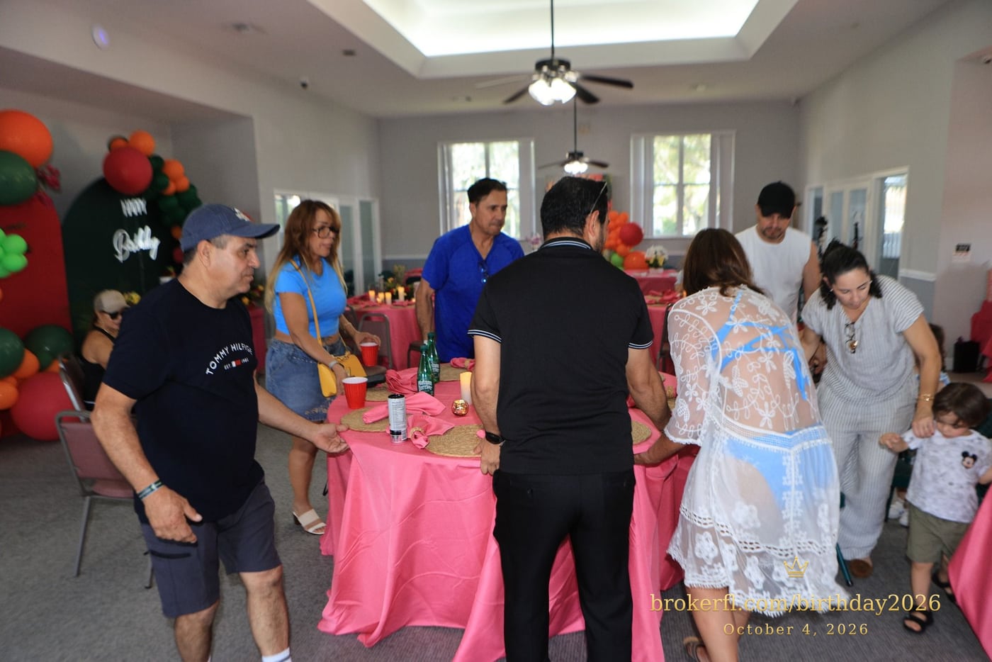 Guests socializing around the indoor party tables — Karina Leal's birthday, October 4, 2026.