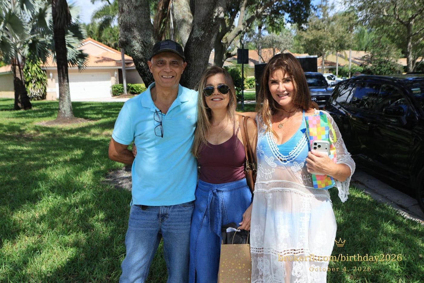 Three guests posing on the lawn outside the venue — Karina Leal's birthday, October 4, 2026.