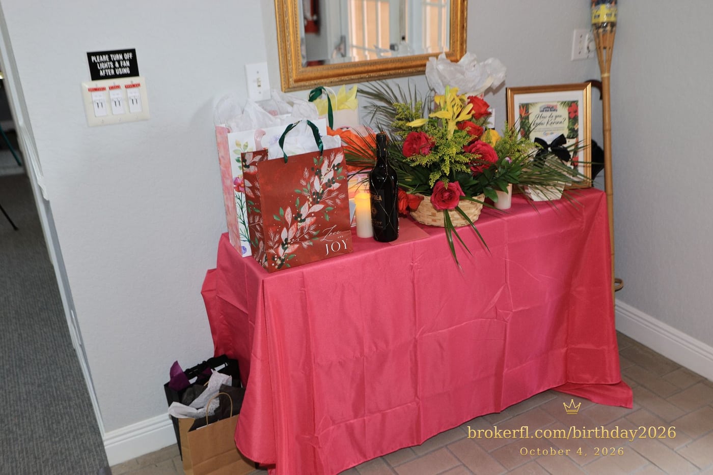 Pink gift table with flowers and wrapped presents — Karina Leal's birthday, October 4, 2026.