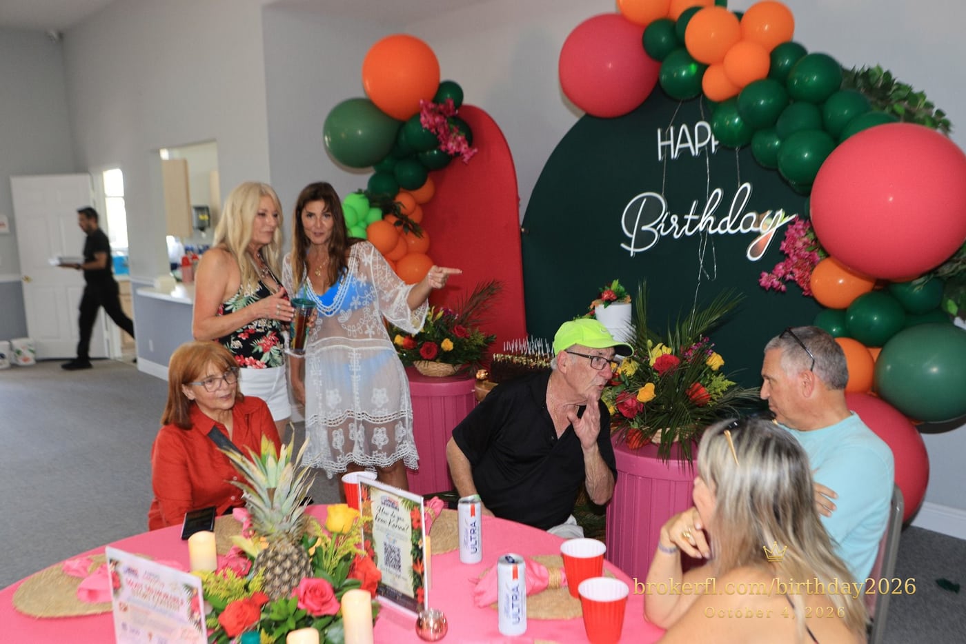 Guests gathered around pink dining tables in the party room — Karina Leal's birthday, October 4, 2026.