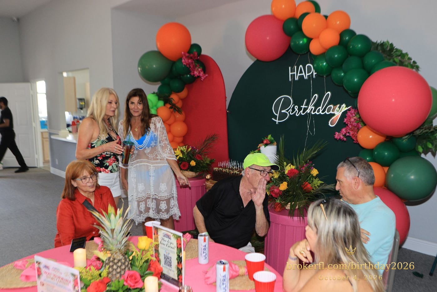 Guests gathered around pink dining tables in the party room — Karina Leal's birthday, October 4, 2026.