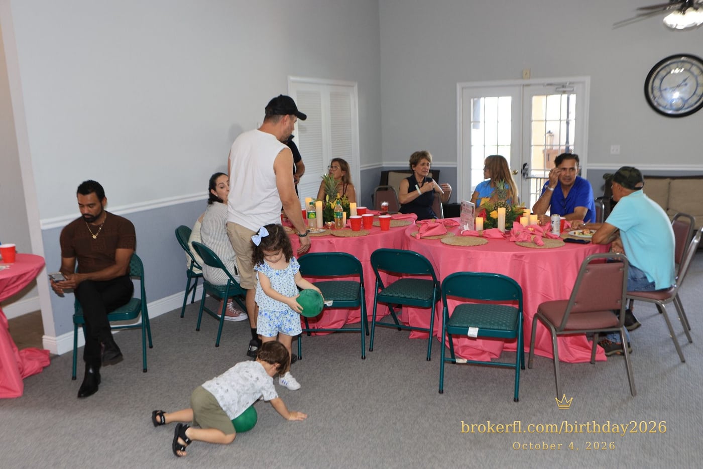 Guests gathered around pink dining tables in the party room — Karina Leal's birthday, October 4, 2026.