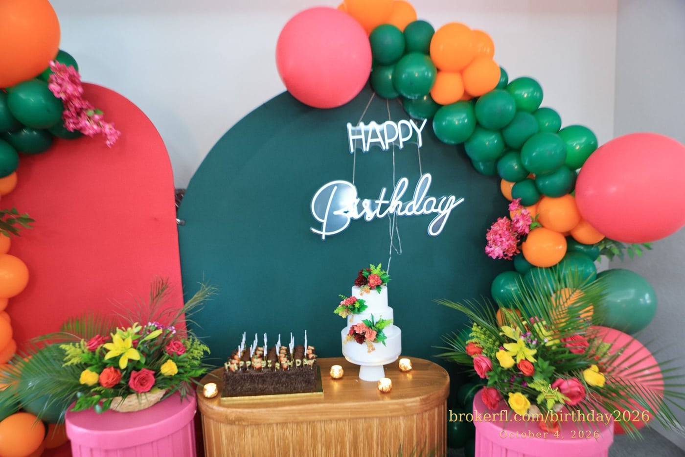 Birthday cake display framed by green and coral balloons — Karina Leal's birthday, October 4, 2026.