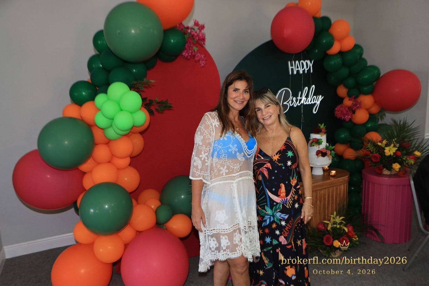 Karina Kfuri Leal with Neildes Esteves, wearing a black floral dress, at Karina’s birthday celebration at Palm Beach Bath & Tennis in Delray Beach.