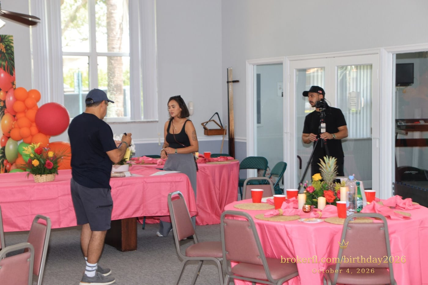 Guests gathered around pink dining tables in the party room — Karina Leal's birthday, October 4, 2026.
