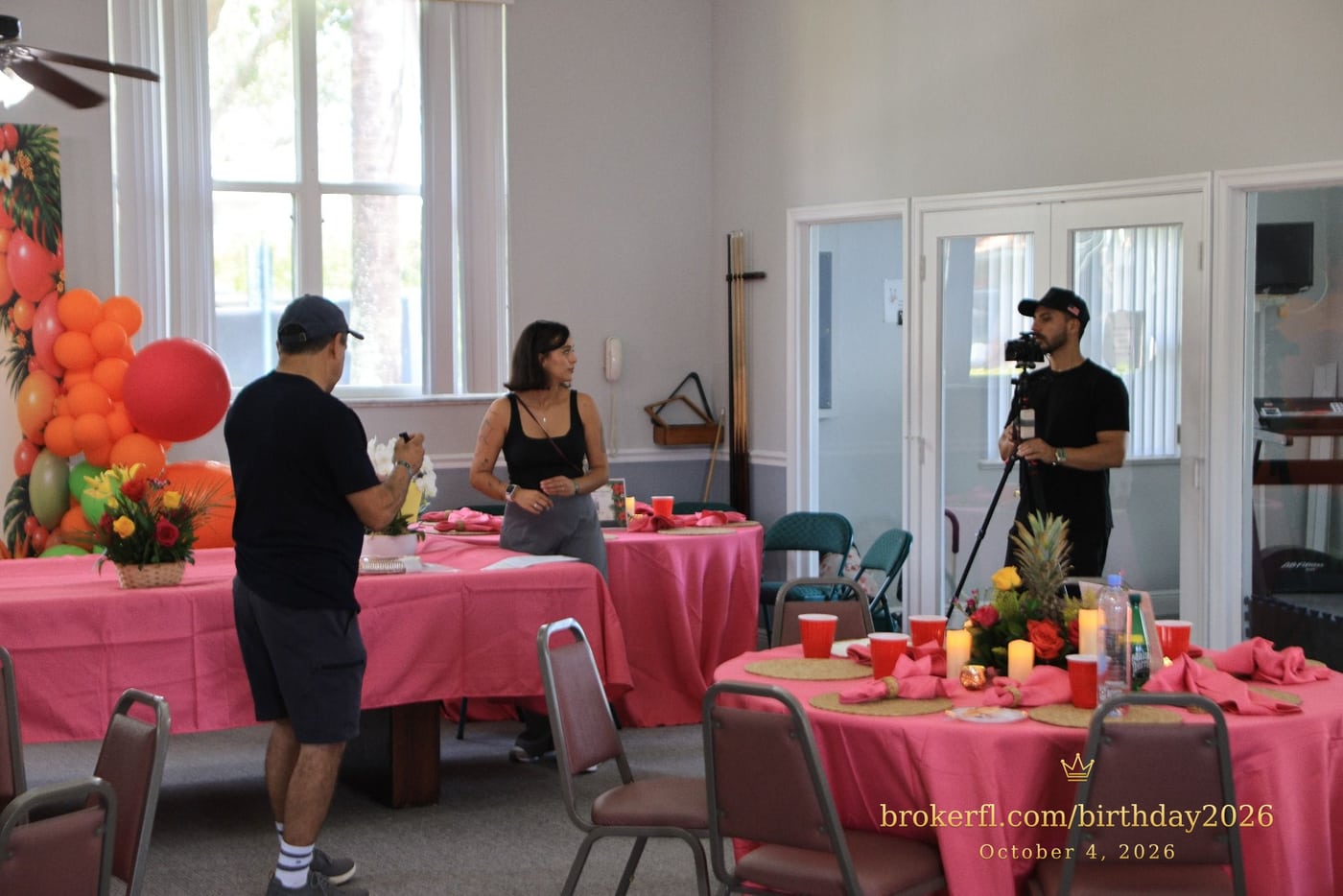 Guests gathered around pink dining tables in the party room — Karina Leal's birthday, October 4, 2026.