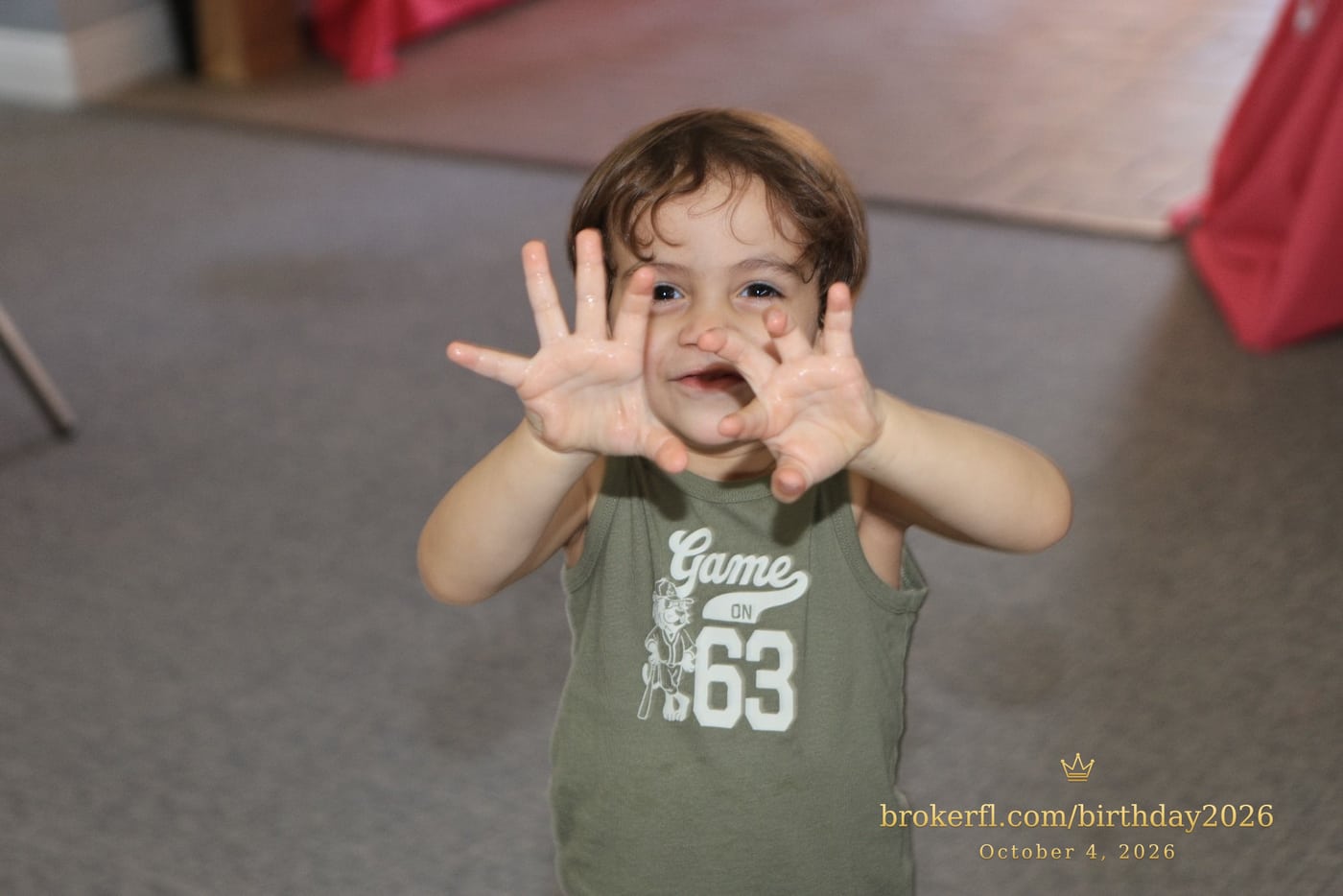 Young guest reaching toward the camera inside the party room — Karina Leal's birthday, October 4, 2026.