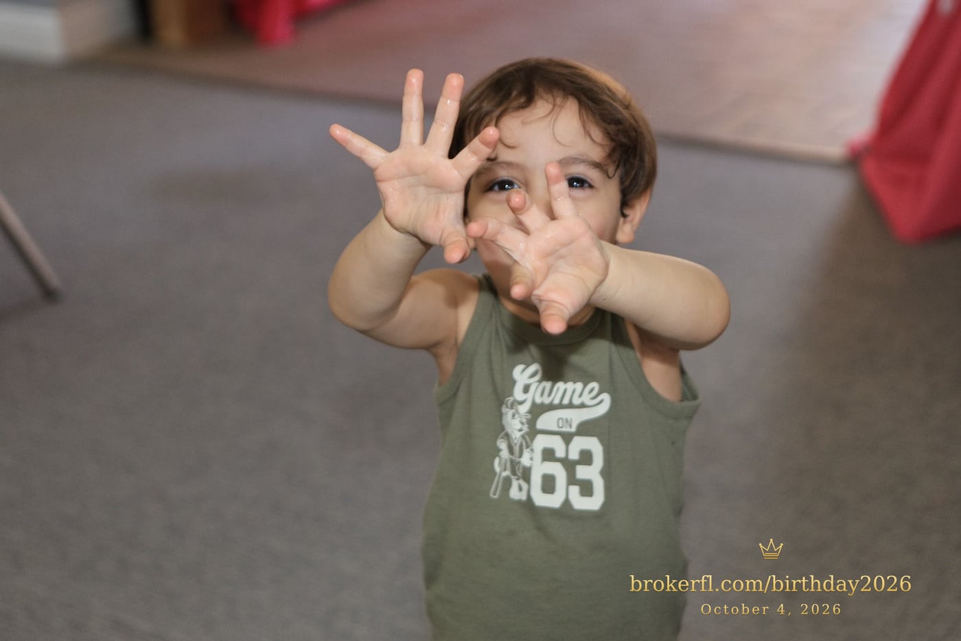 Young guest reaching toward the camera inside the party room — Karina Leal's birthday, October 4, 2026.
