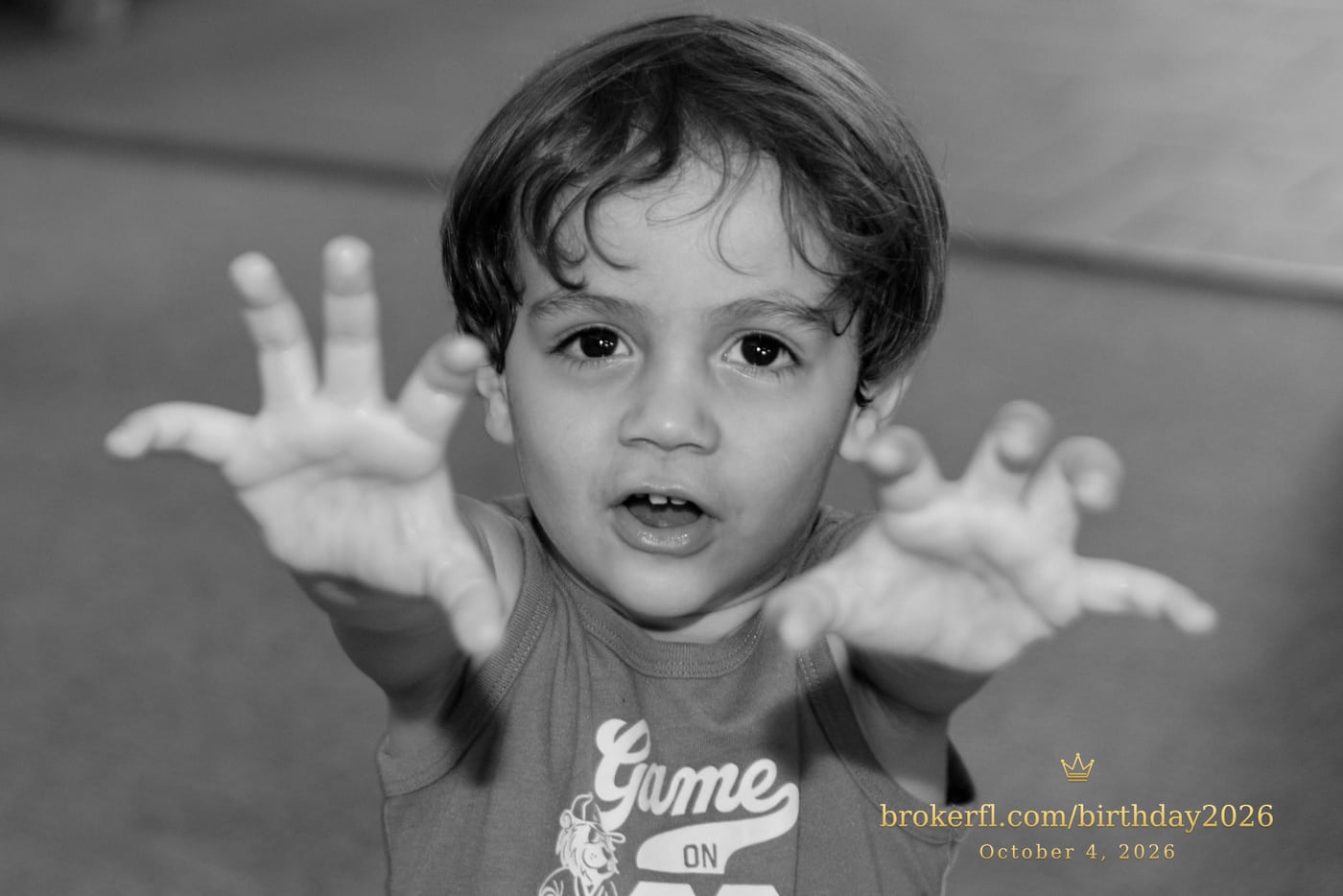 Black-and-white portrait of a young guest reaching toward the camera — Karina Leal's birthday, October 4, 2026.