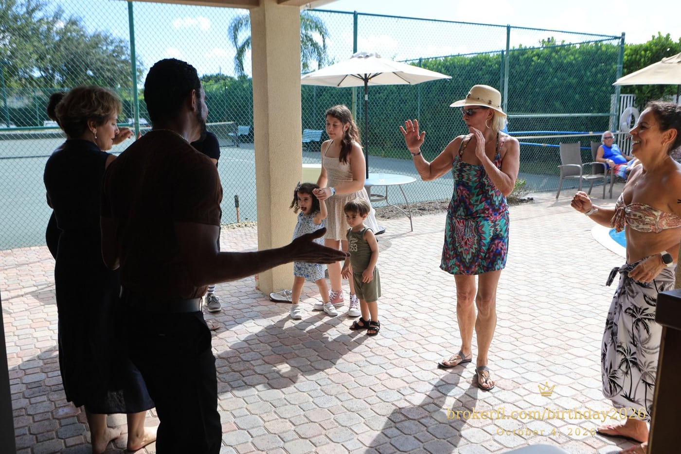 Friends dancing together on the poolside patio — Karina Leal's birthday, October 4, 2026.