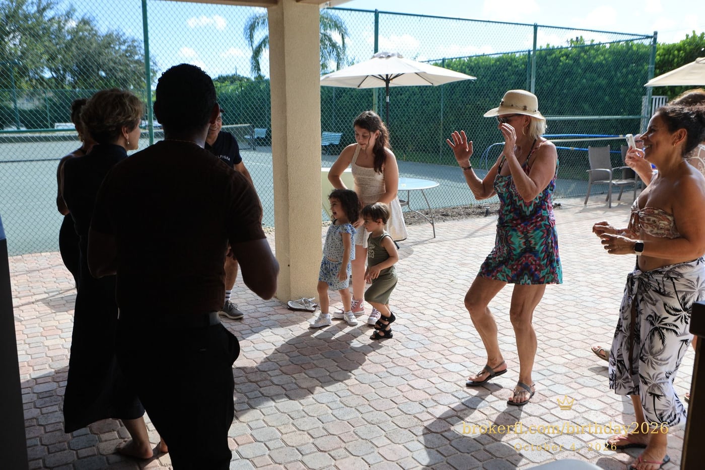 Friends dancing together on the poolside patio — Karina Leal's birthday, October 4, 2026.
