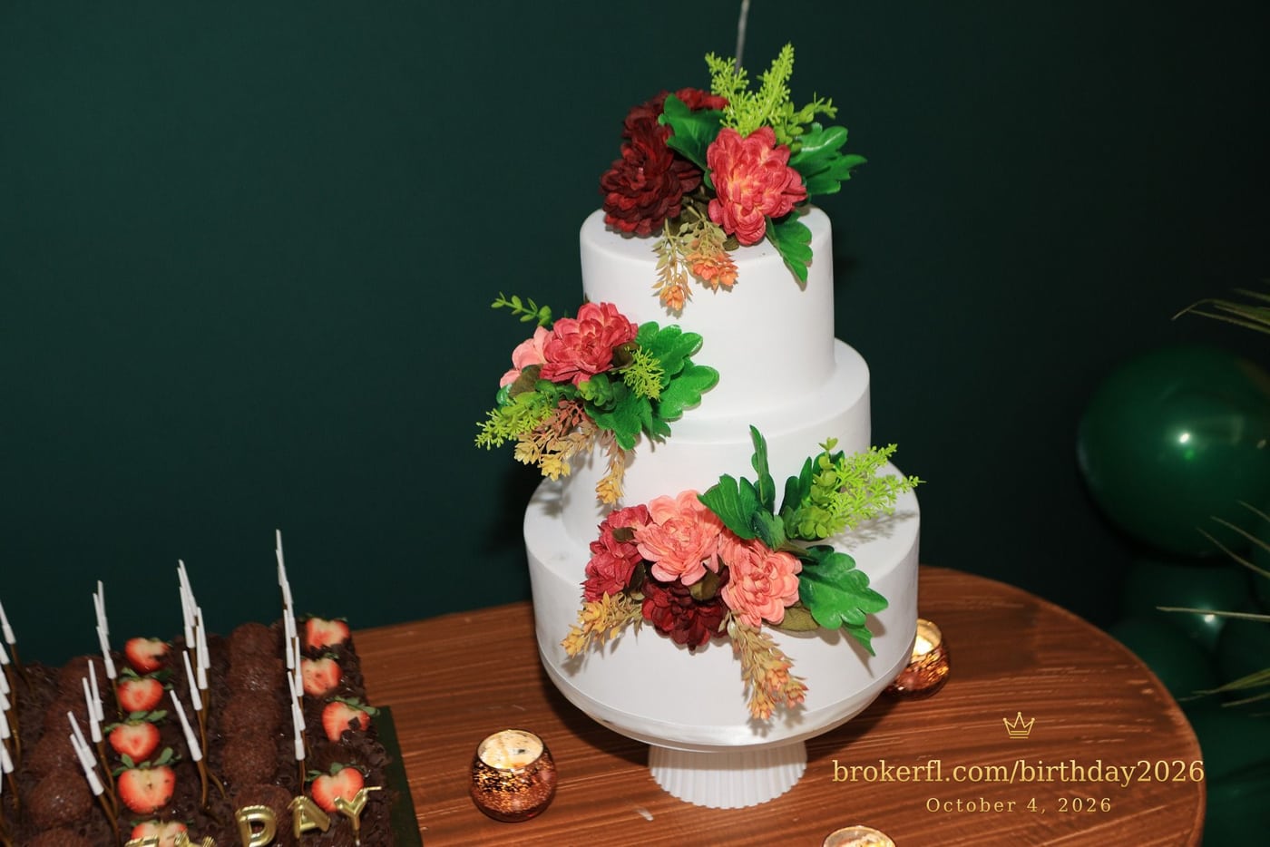 Tiered birthday cake decorated with tropical flowers — Karina Leal's birthday, October 4, 2026.