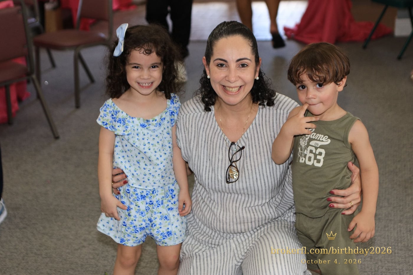 Adult posing with two young guests inside the party room — Karina Leal's birthday, October 4, 2026.