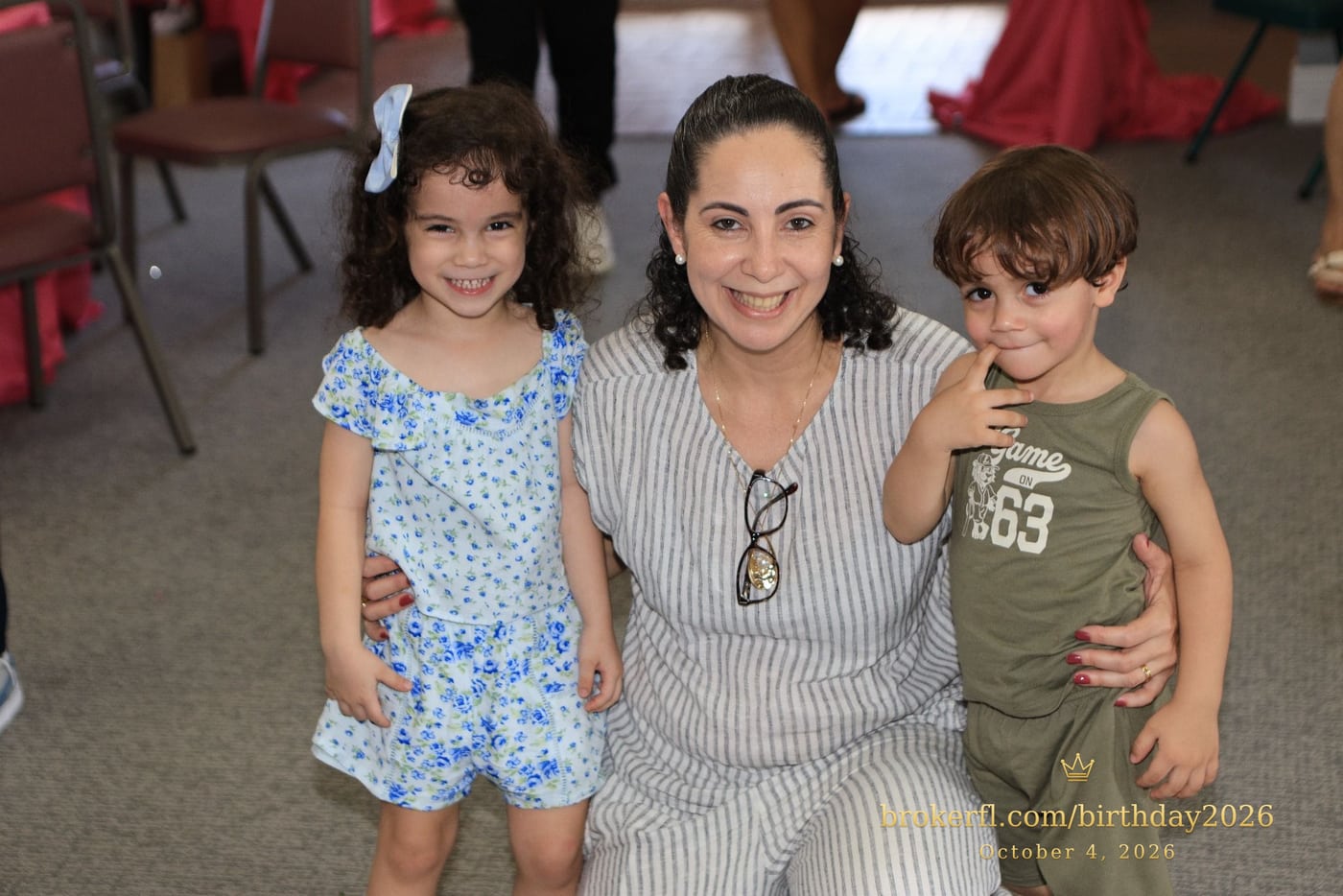 Adult posing with two young guests inside the party room — Karina Leal's birthday, October 4, 2026.