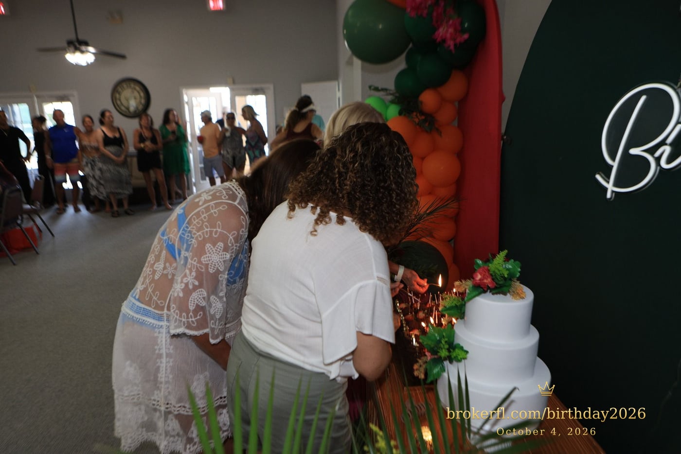Birthday cake table surrounded by guests — Karina Leal's birthday, October 4, 2026.