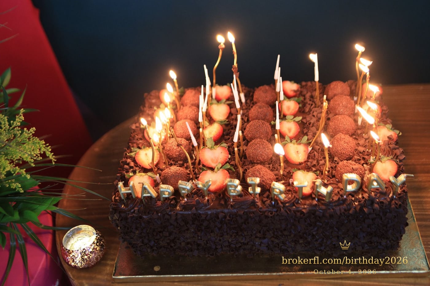 Lit candles on the chocolate birthday cake — Karina Leal's birthday, October 4, 2026.