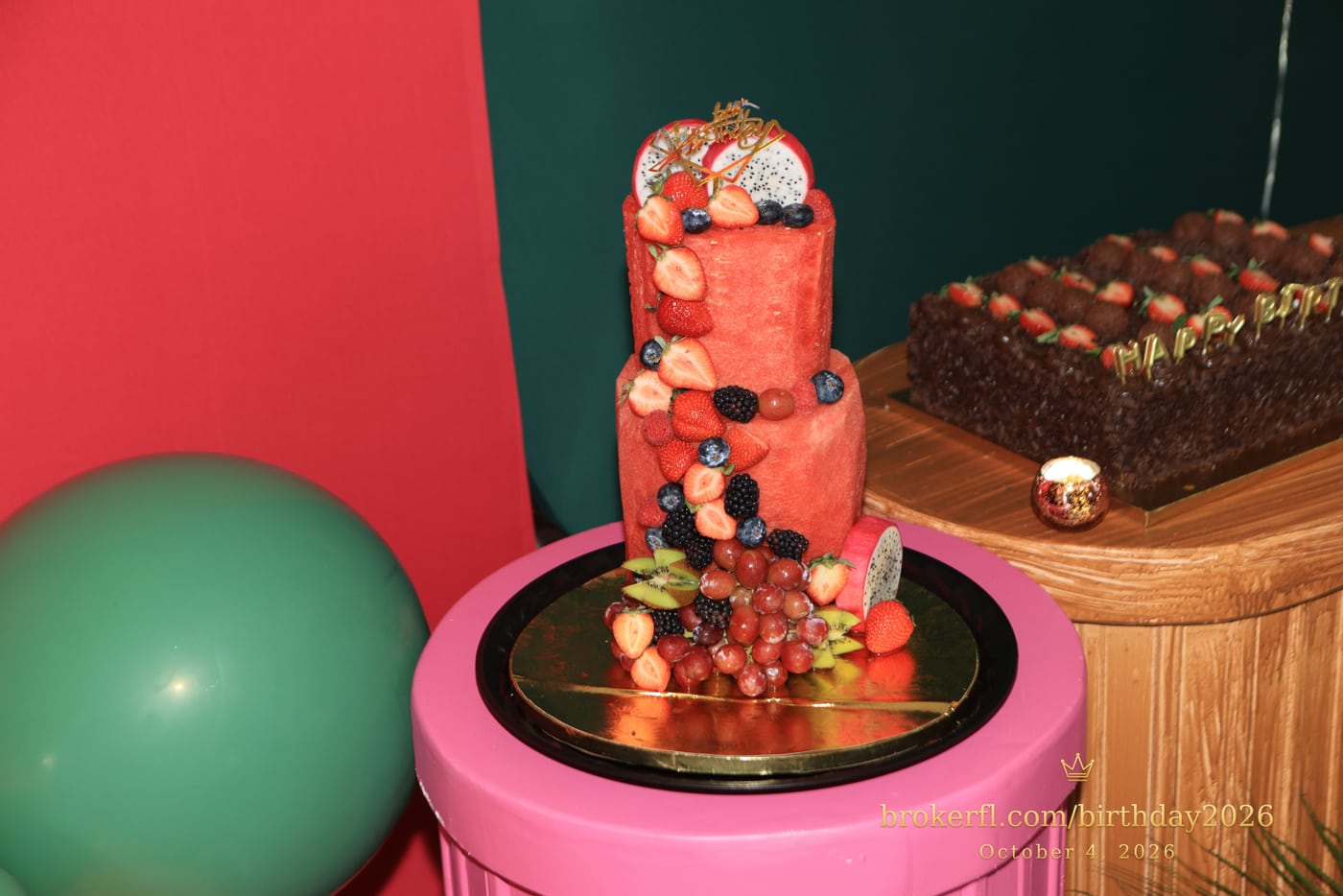 Red tiered birthday cake with colorful decorations — Karina Leal's birthday, October 4, 2026.
