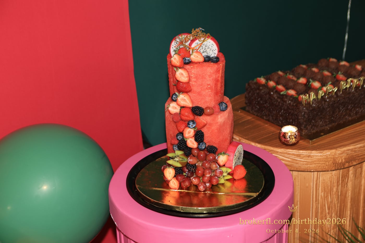 Red tiered birthday cake with colorful decorations — Karina Leal's birthday, October 4, 2026.