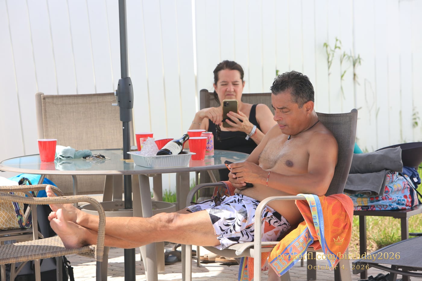 Friends sharing a table on the poolside patio — Karina Leal's birthday, October 4, 2026.