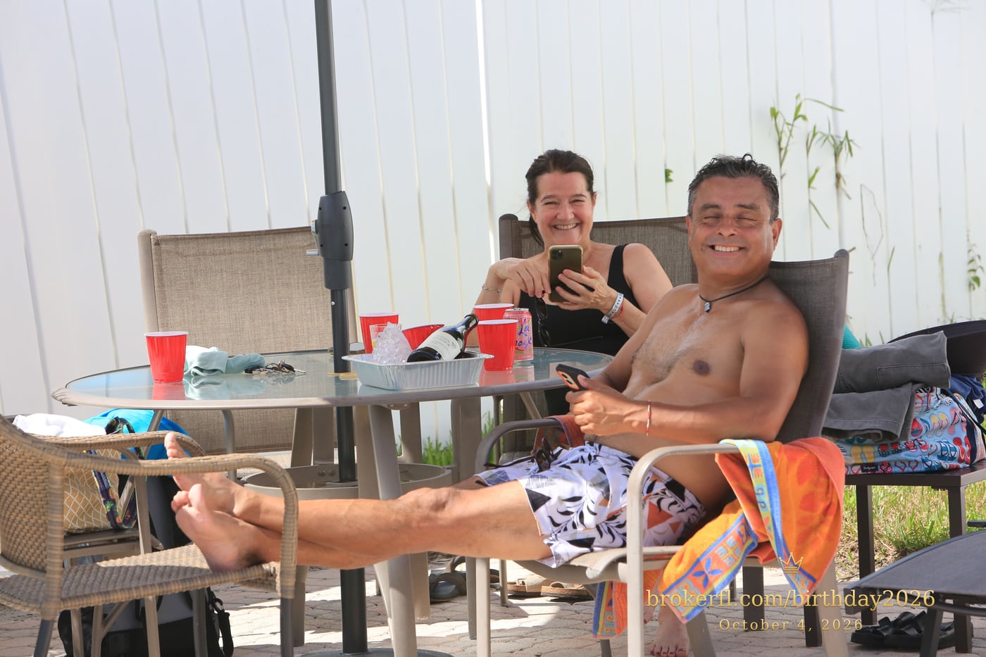Friends sharing a table on the poolside patio — Karina Leal's birthday, October 4, 2026.
