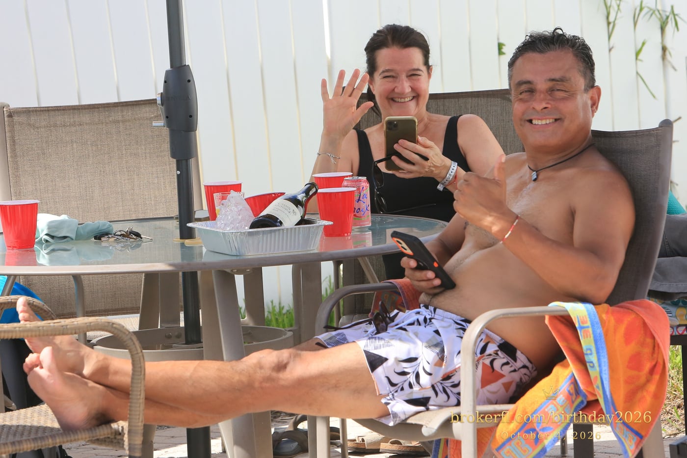 Friends sharing a table on the poolside patio — Karina Leal's birthday, October 4, 2026.