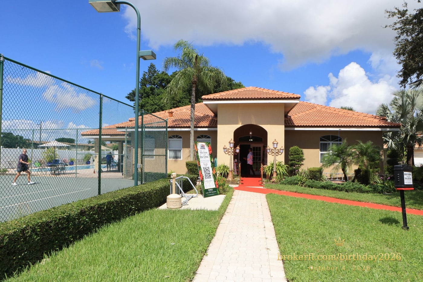 Venue entrance with a red carpet and tropical party signs — Karina Leal's birthday, October 4, 2026.