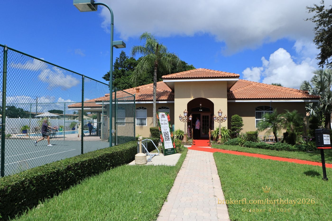 Venue entrance with a red carpet and tropical party signs — Karina Leal's birthday, October 4, 2026.